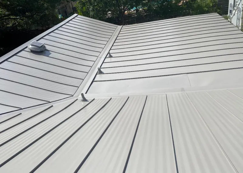 Solar attic fan installed on a metal roof for Roof Ventilation in Palos Hills